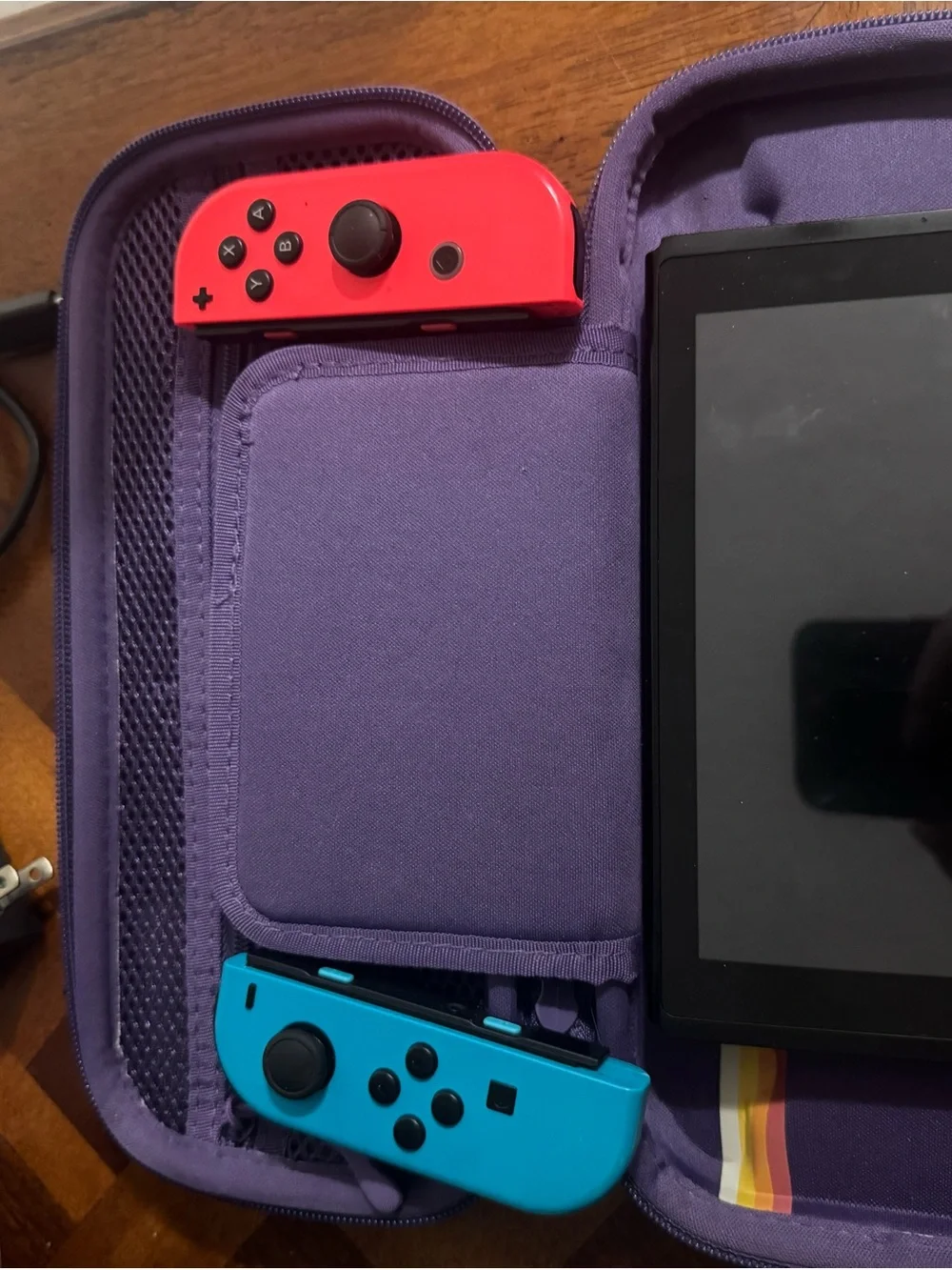 Nintendo Switch with Blue Left & Red Right Joy-Con and Purple Carry Case